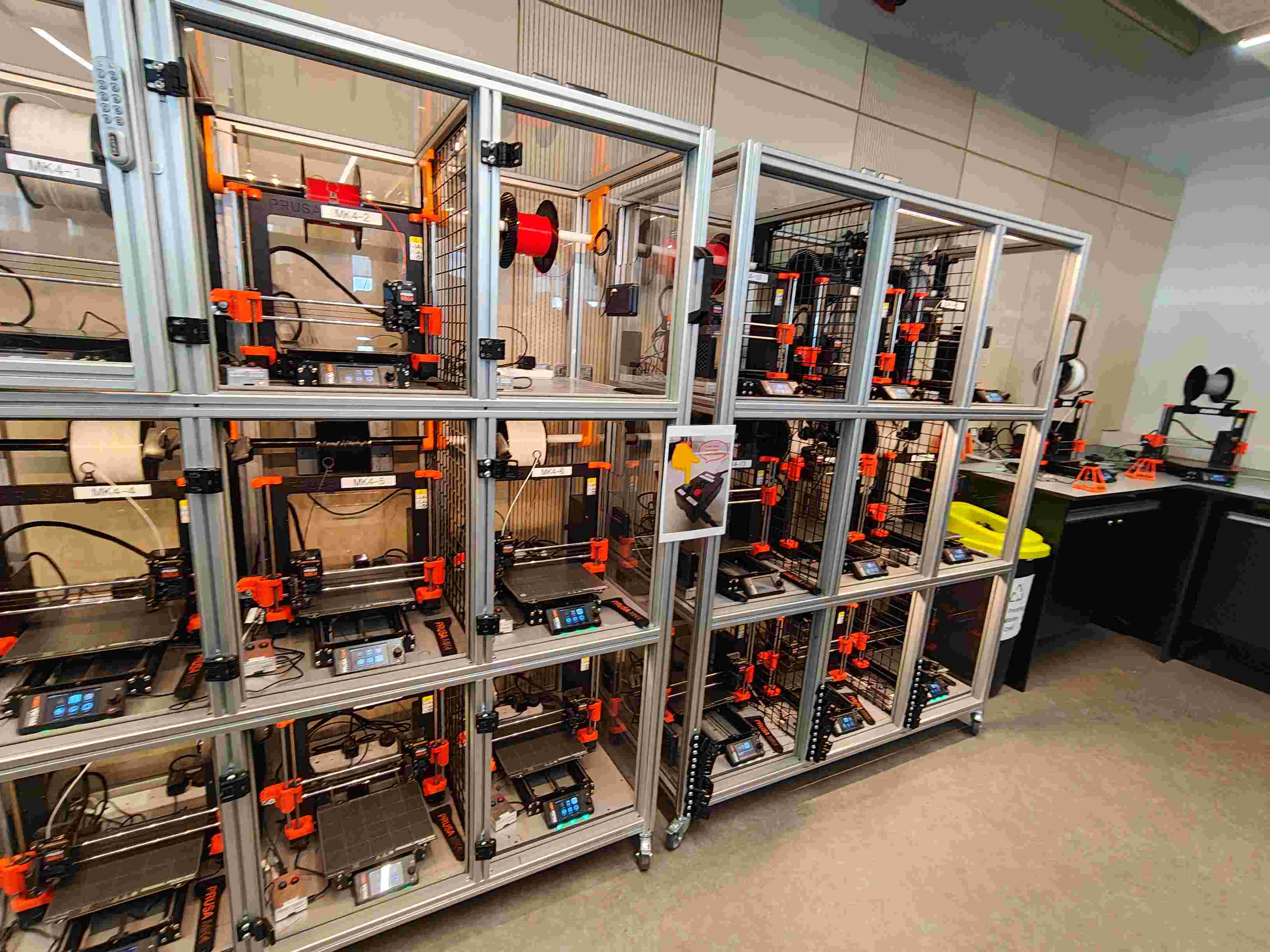 24 Prusa MK4 printers in individual polycarbonate enclosures on modular aluminium racks